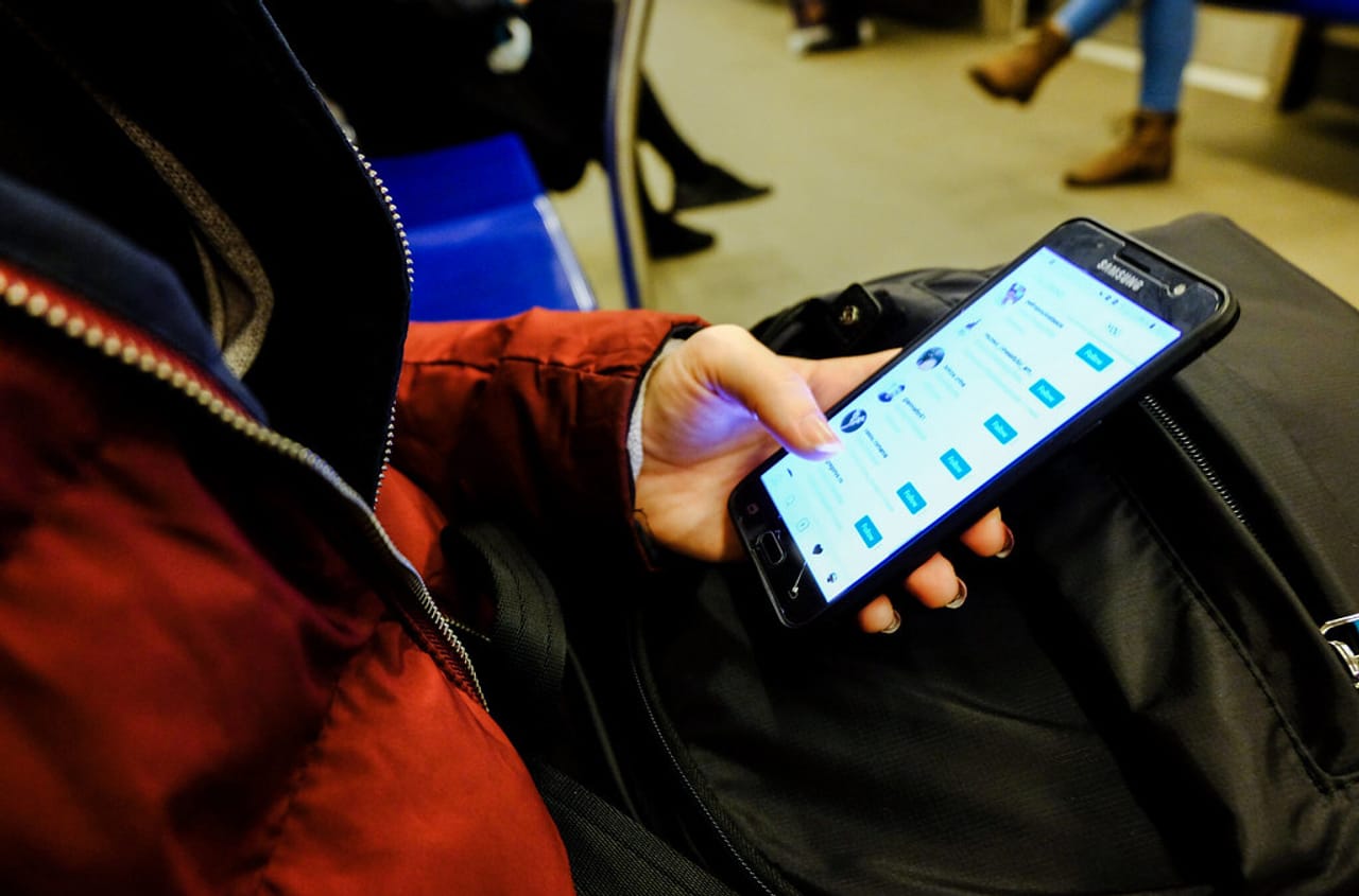スマートフォンでSNSアプリを操作する手元